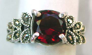 Discount sterling silver wholesale, sterling silver ring design with a red topaz and leaf around