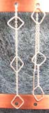 Genius sterling silver ear clip earring with long chain handing a ear 